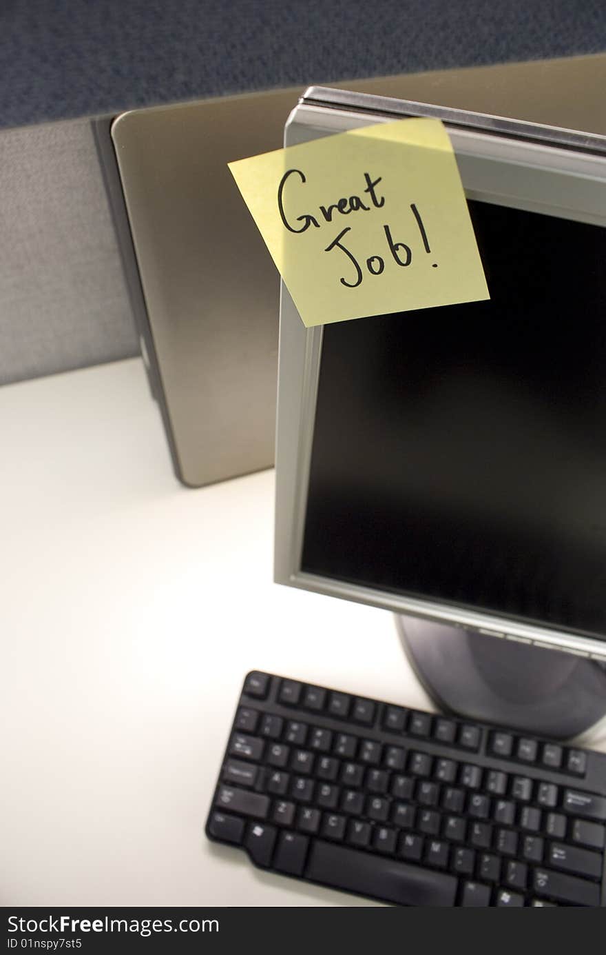 PC at desk with good job note. PC at desk with good job note