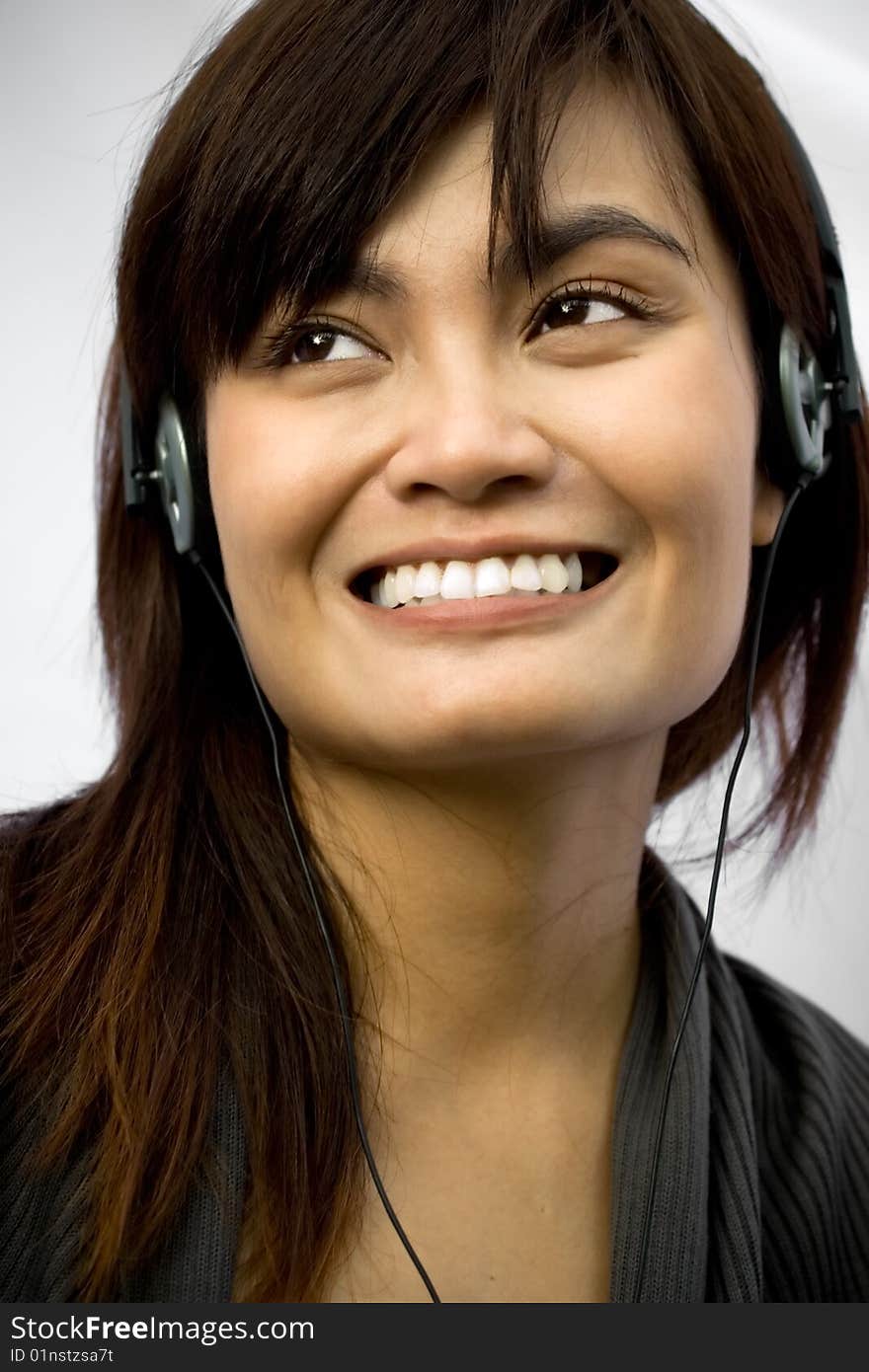 Happy asian young woman with headphone listening music on white background. Happy asian young woman with headphone listening music on white background