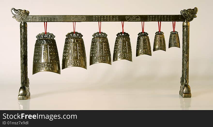 Chinese ancient bronze bell(reproduction) on the white background. Chinese ancient bronze bell(reproduction) on the white background.