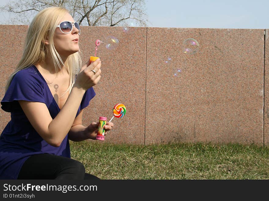 Funny girl blowing soap bubbles