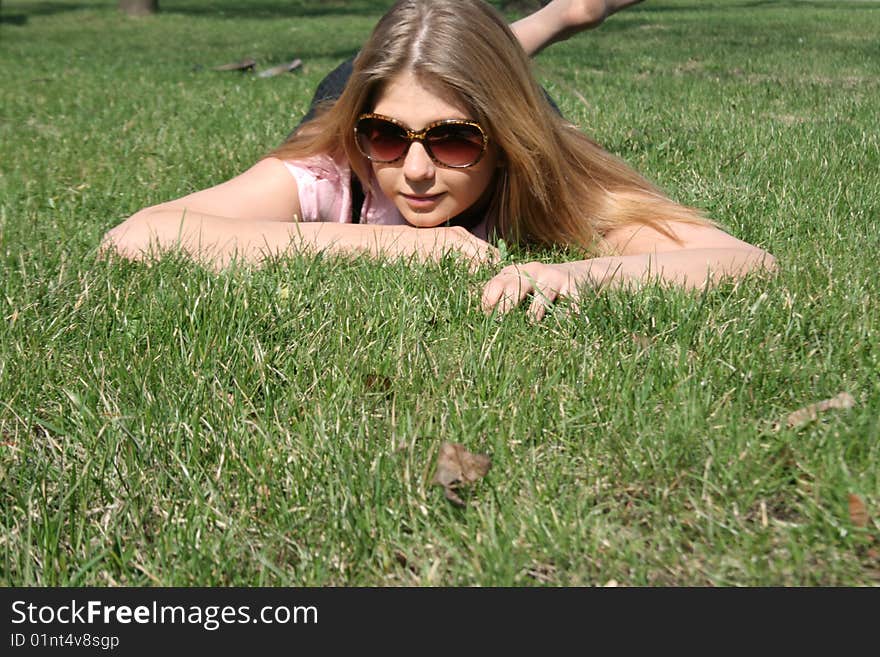 Girl lying on grass in a park