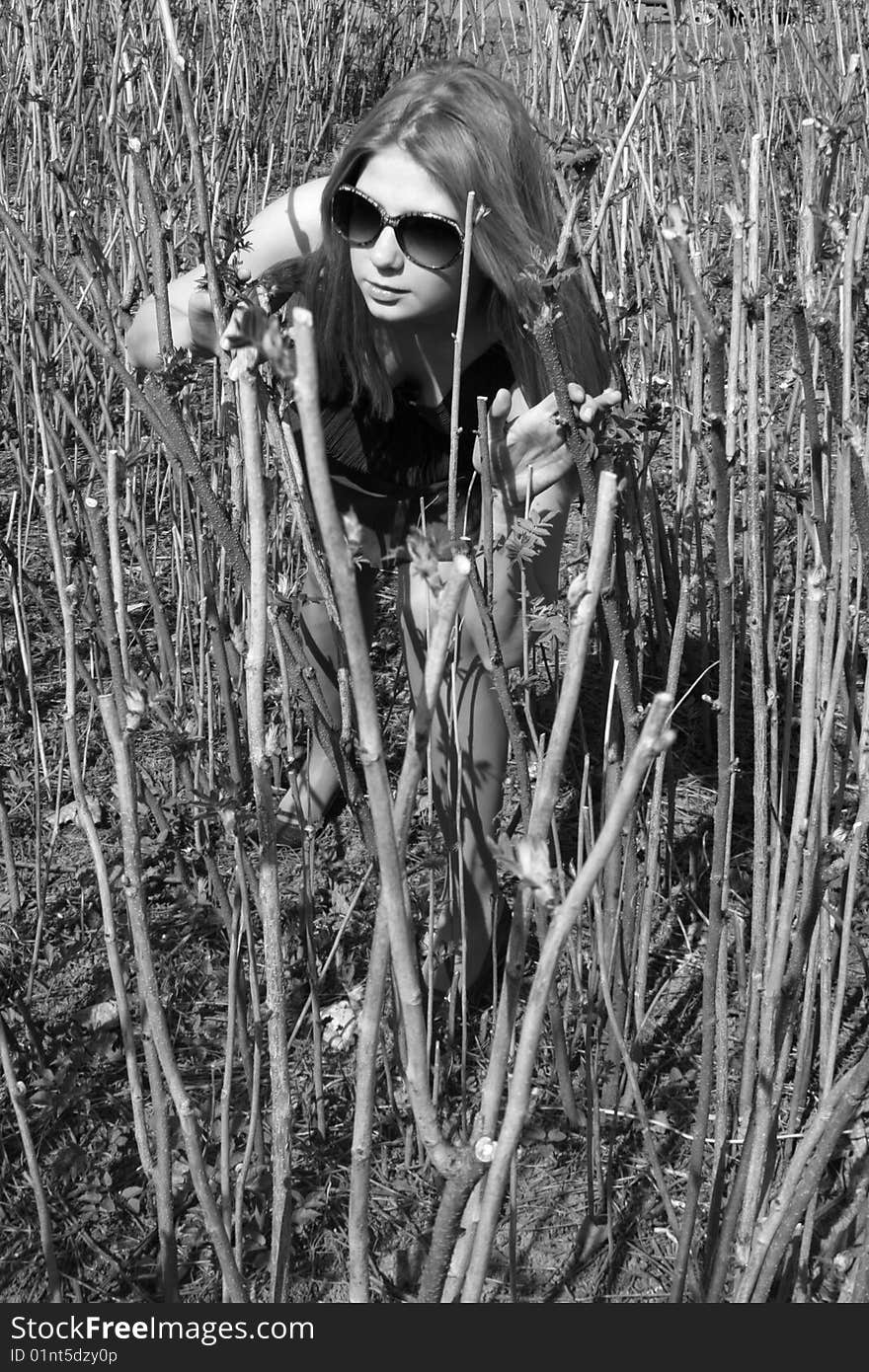 Girl Making Her Way Through Bushes