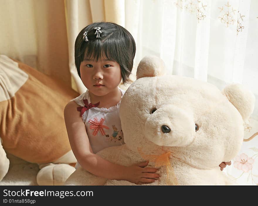 A little and her white teddy bear. A little and her white teddy bear