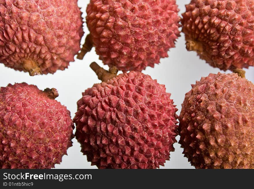 A selection of lychees against a white background. A selection of lychees against a white background