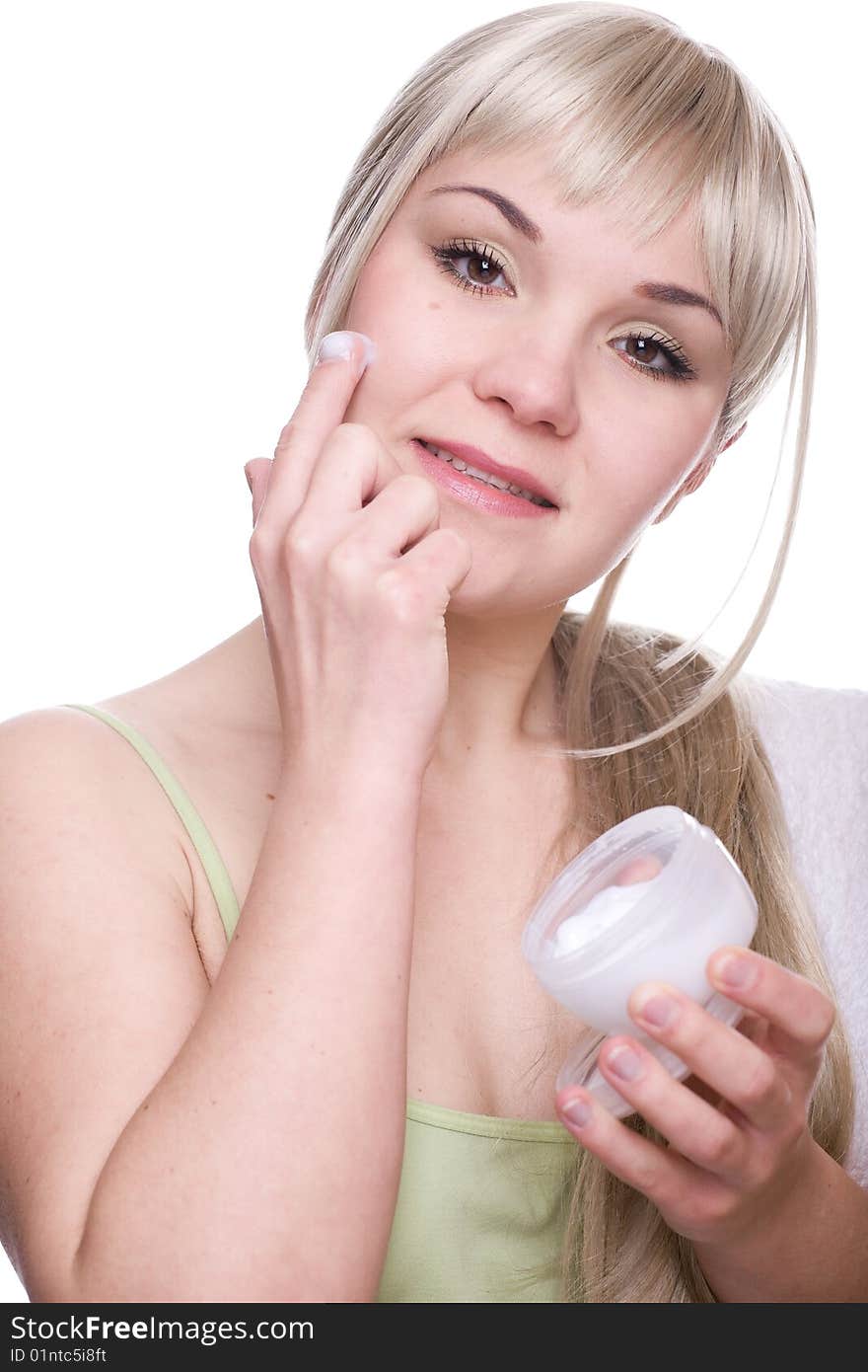 Attractive woman applying cream over white background. Attractive woman applying cream over white background