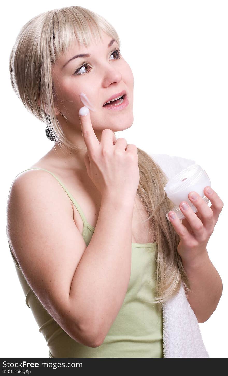 Attractive woman applying cream over white background. Attractive woman applying cream over white background