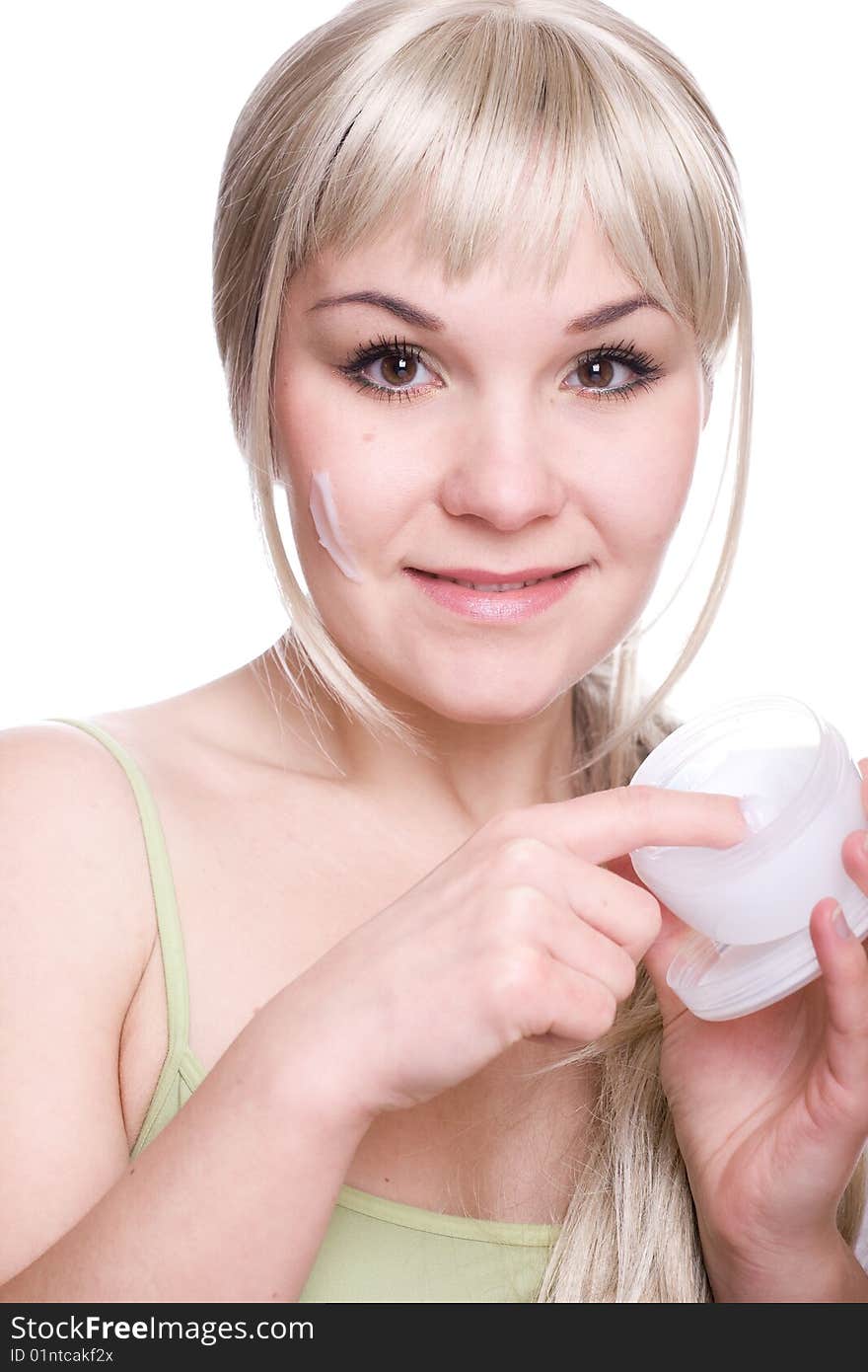 Attractive woman applying cream over white background. Attractive woman applying cream over white background