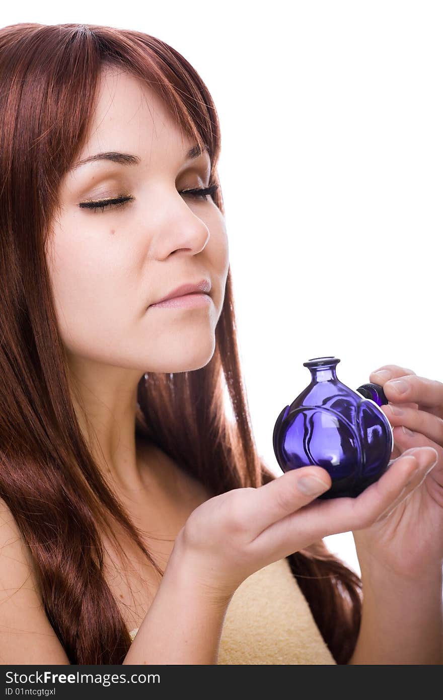 Attractive young woman with perfume bottle. over white background. Attractive young woman with perfume bottle. over white background