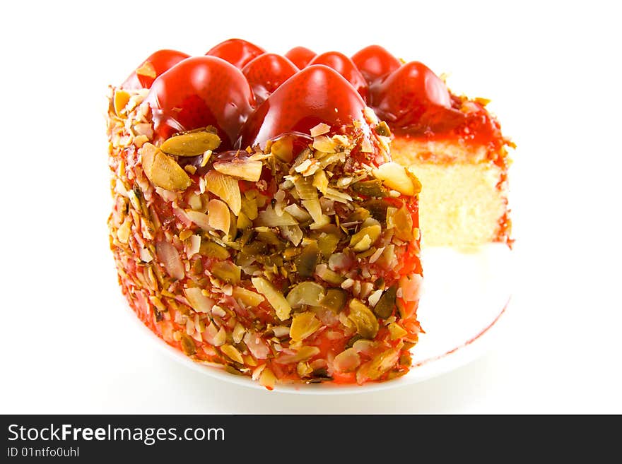 Single delicious looking strawberry topped new york style cheesecake on a white background. Single delicious looking strawberry topped new york style cheesecake on a white background