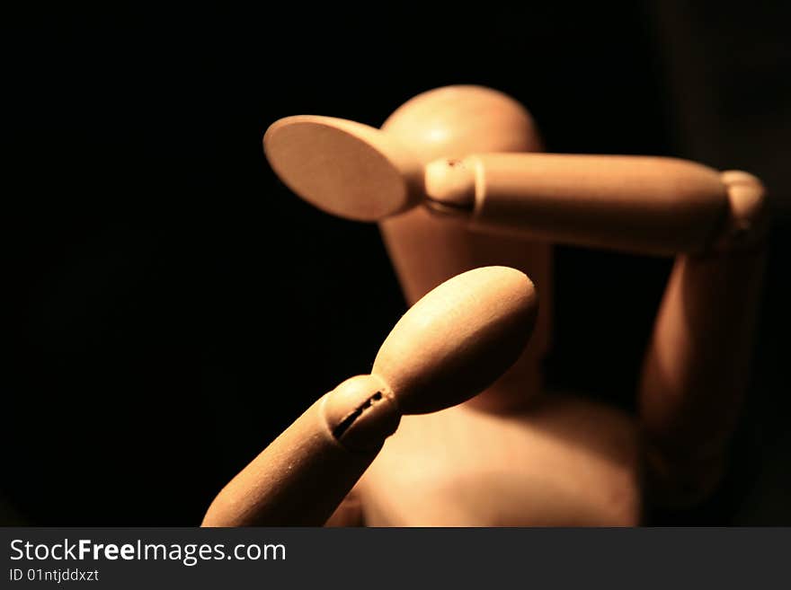 A wooden man on black background. A wooden man on black background