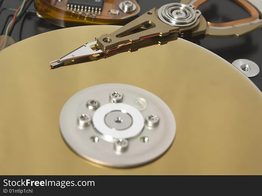 Closeup of the platters and read/write head of a computer hard drive. Closeup of the platters and read/write head of a computer hard drive