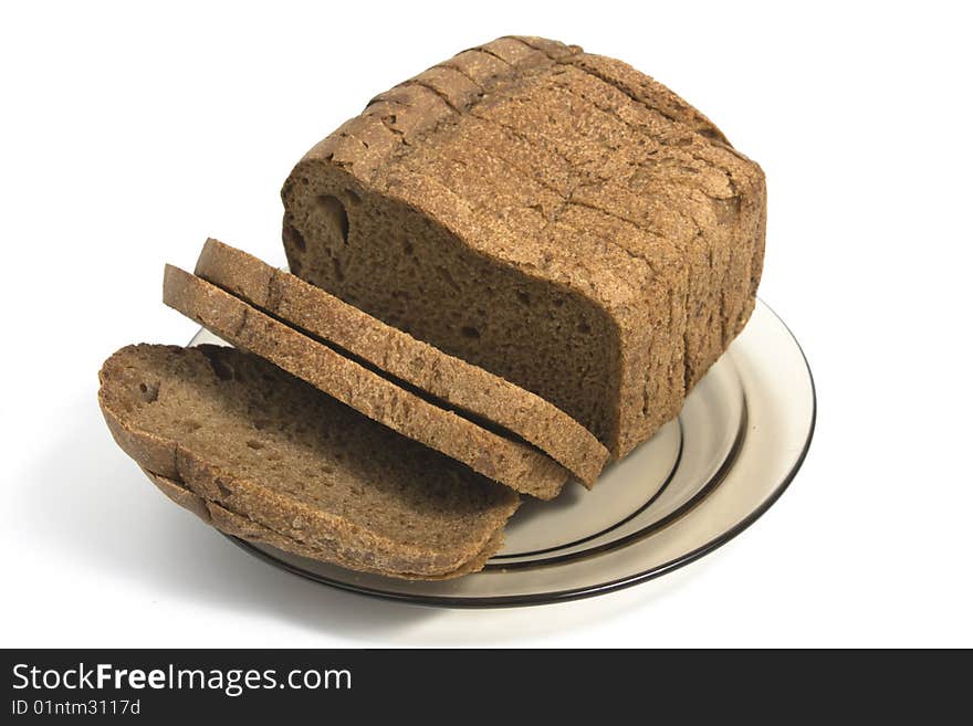 Dark bread on glass plate isolated on white