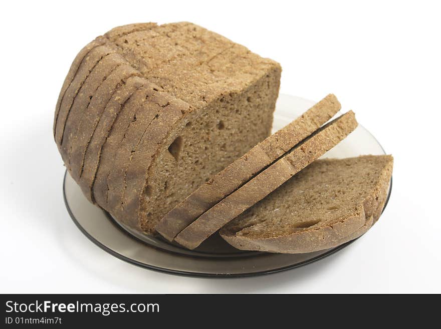 Dark bread on glass plate isolated on white