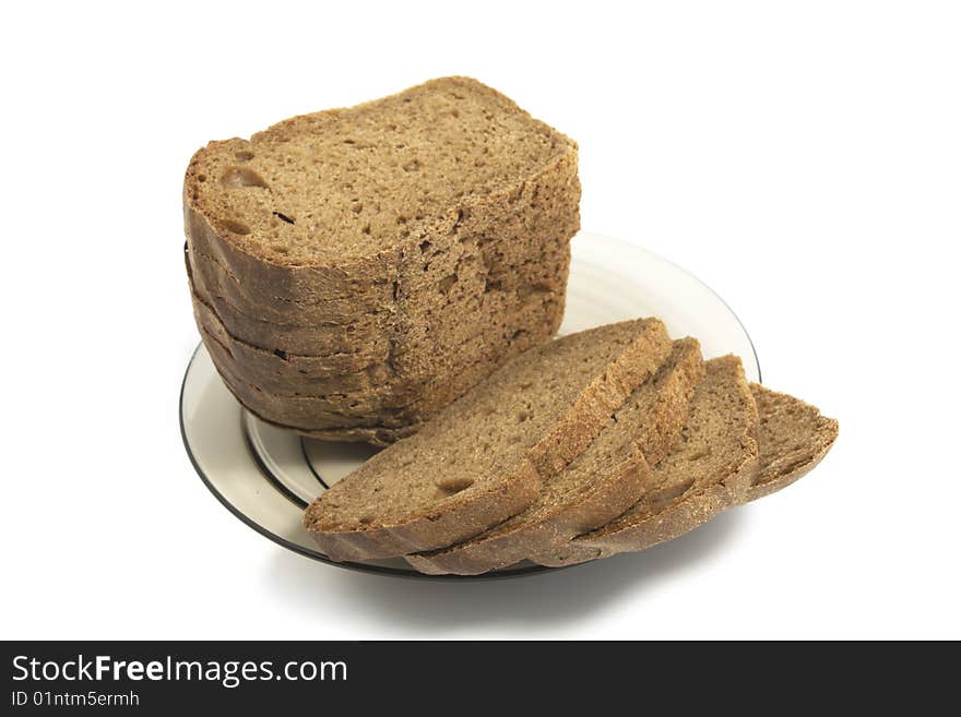 Dark bread on glass plate isolated on white