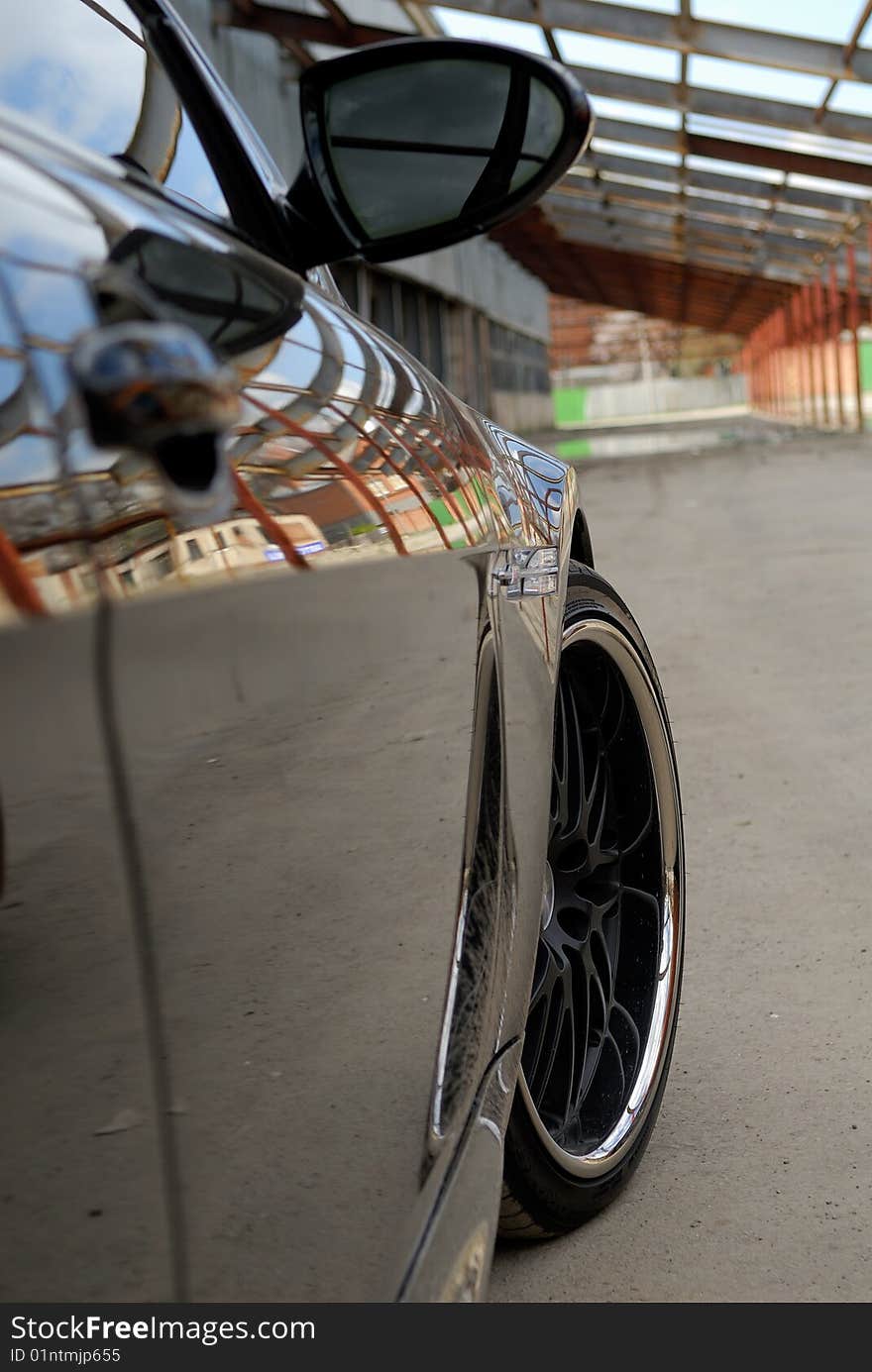 Black car fragment with reflection