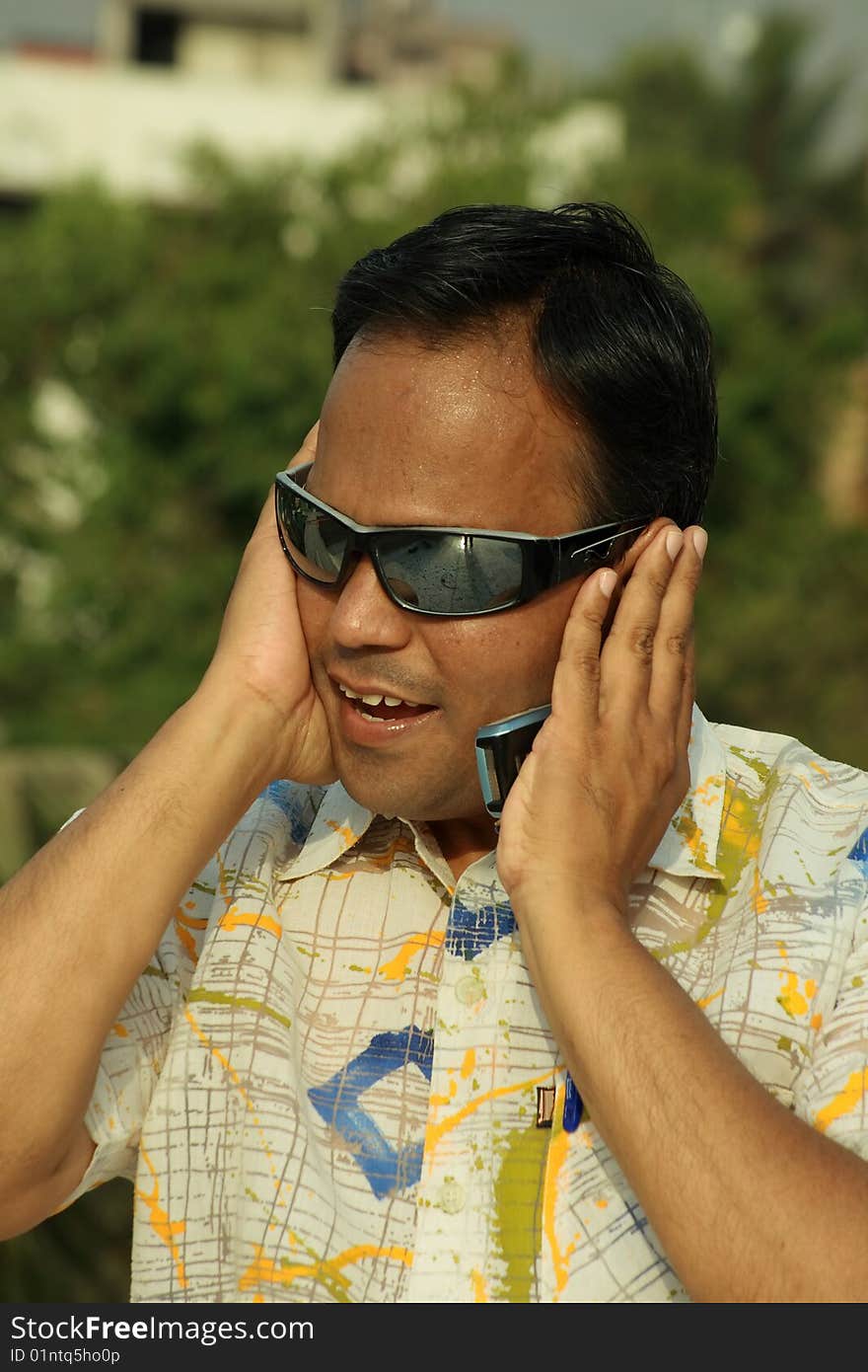 A young Indian man unable to bear the excitement after listening the news. A young Indian man unable to bear the excitement after listening the news.