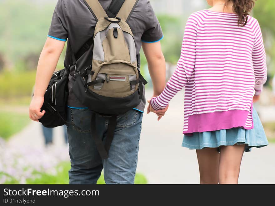 Lovers couple holding hands walking in faubourg