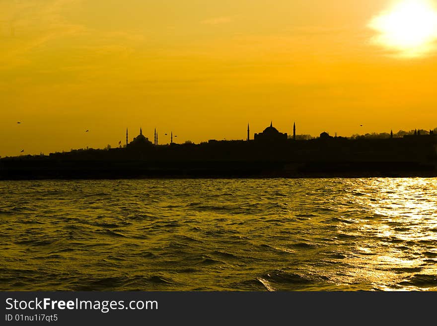 The view of Blue mosque and Hagia Sofia after sunset from Uskudar