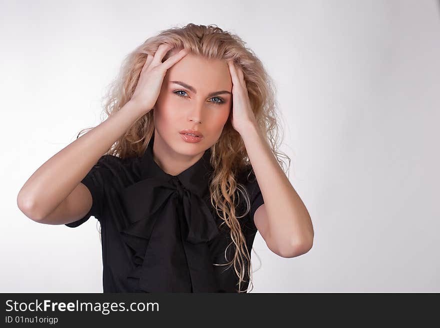 Girl in black blouse having a headache, studio shot