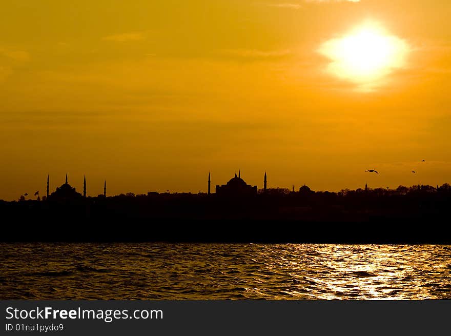 The view of Blue mosque and Hagia Sofia after sunset from Uskudar