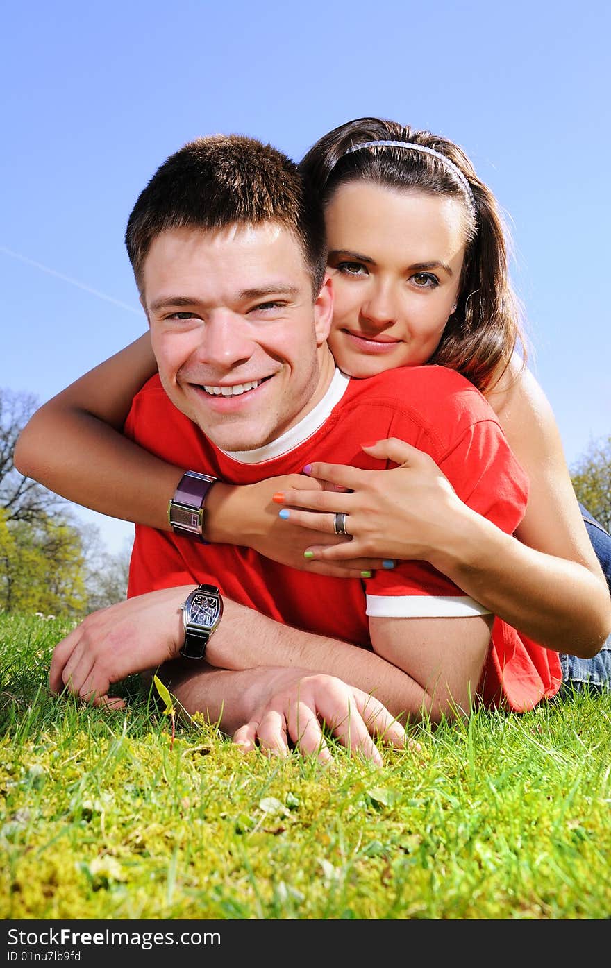 A happy couple on a green meadow, summer day