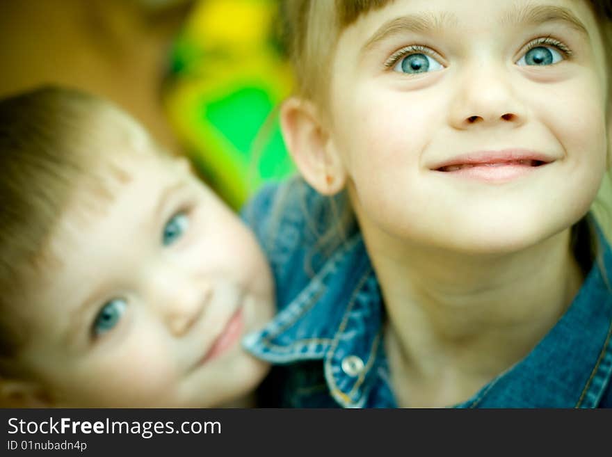 Two siblings embrace each other and laughing happily.