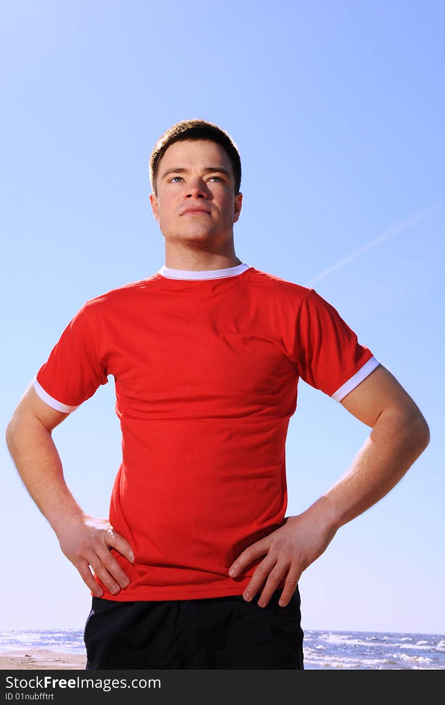 Young Man Standing At Beach