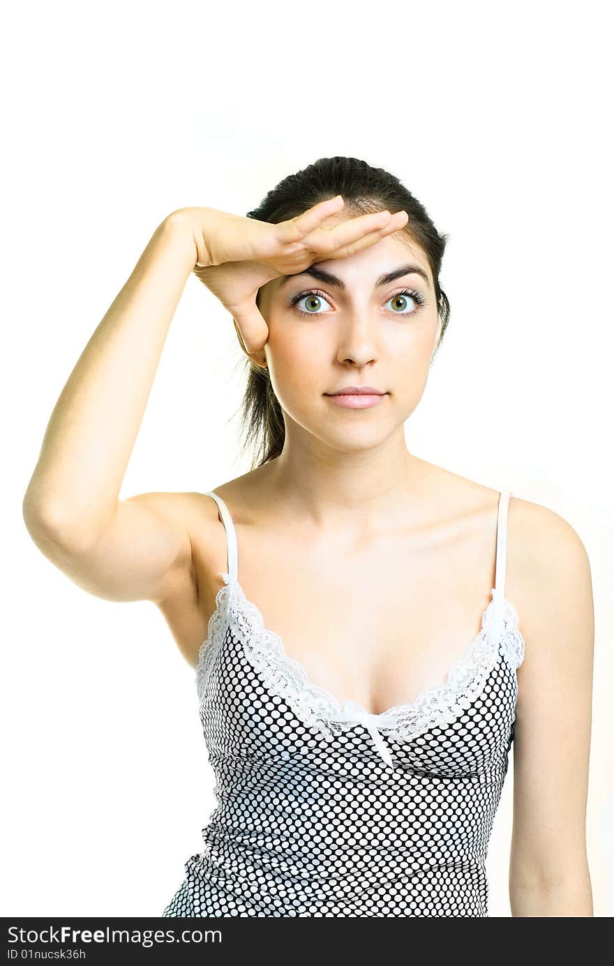 Pretty brunette girl looking at something and closing her eyes from the Sun