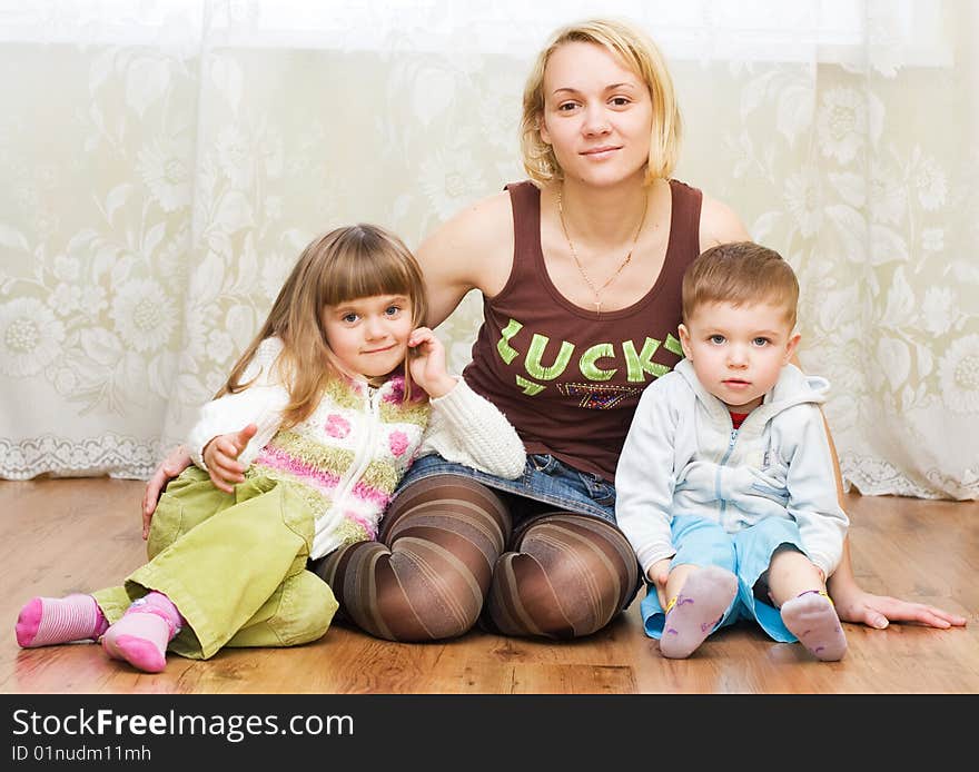 Mother with son and daughter on a floor