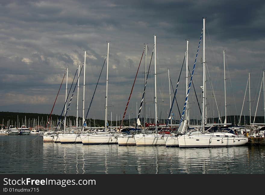 The yacht marina with dark sky background. Croatia.