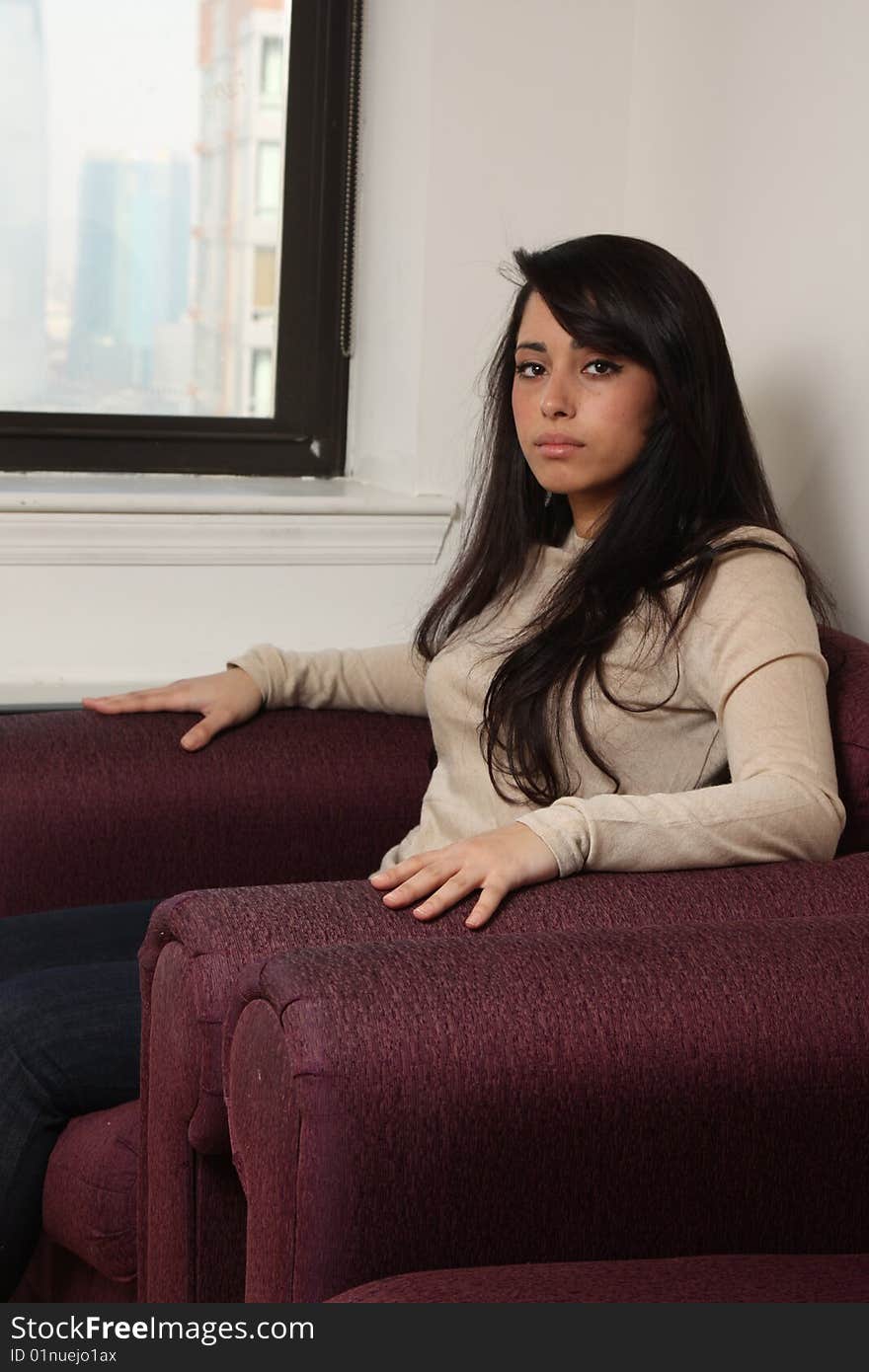 Young female sitting in arm chair. Young female sitting in arm chair