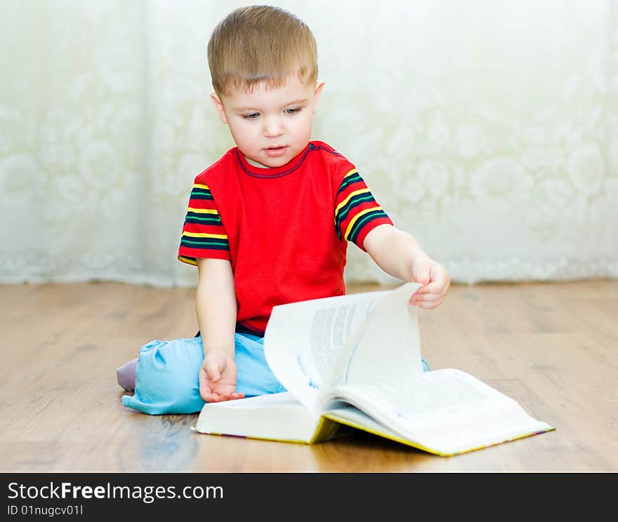 A little boy reads a book