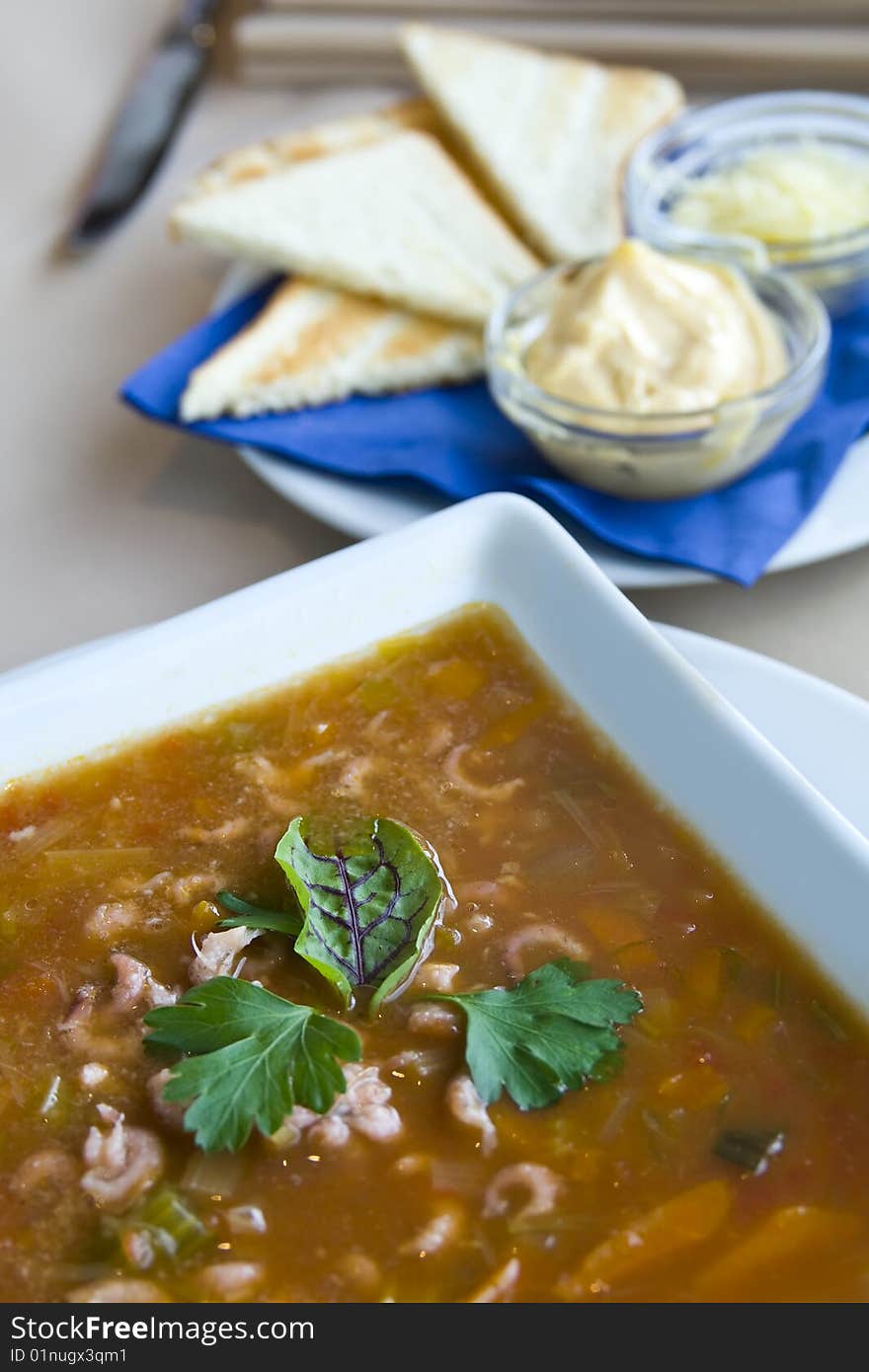 Seafood soup with cheese toast triangles