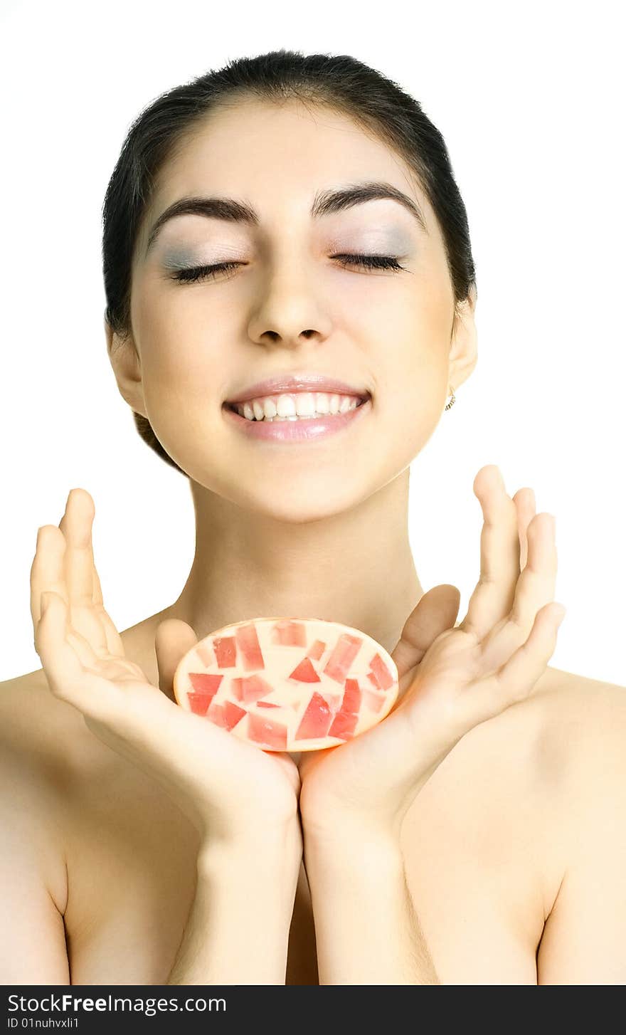 Pretty young brunette woman holding a soap in her hands. Pretty young brunette woman holding a soap in her hands