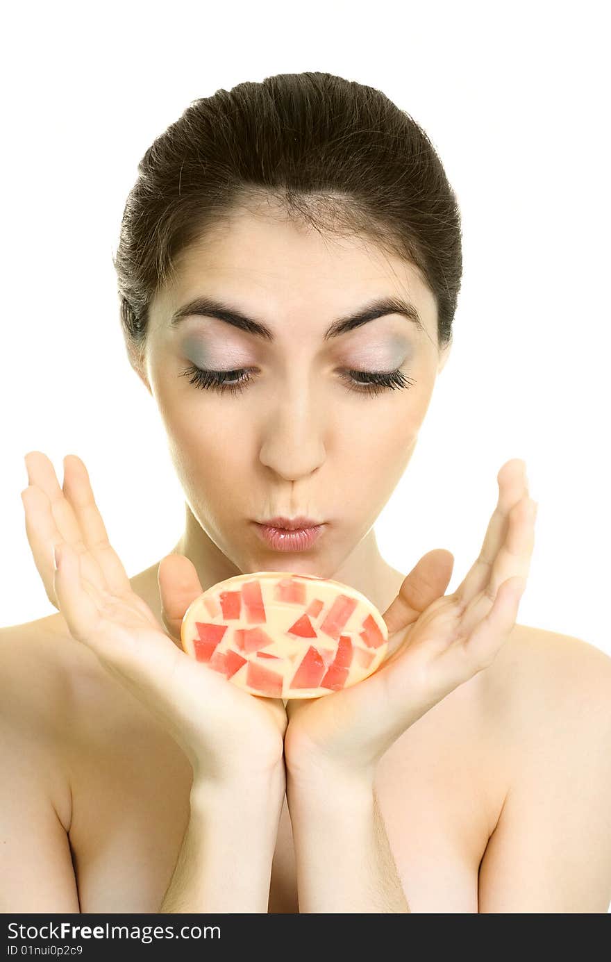 Pretty young surprised woman holding a soap in her hands. Pretty young surprised woman holding a soap in her hands