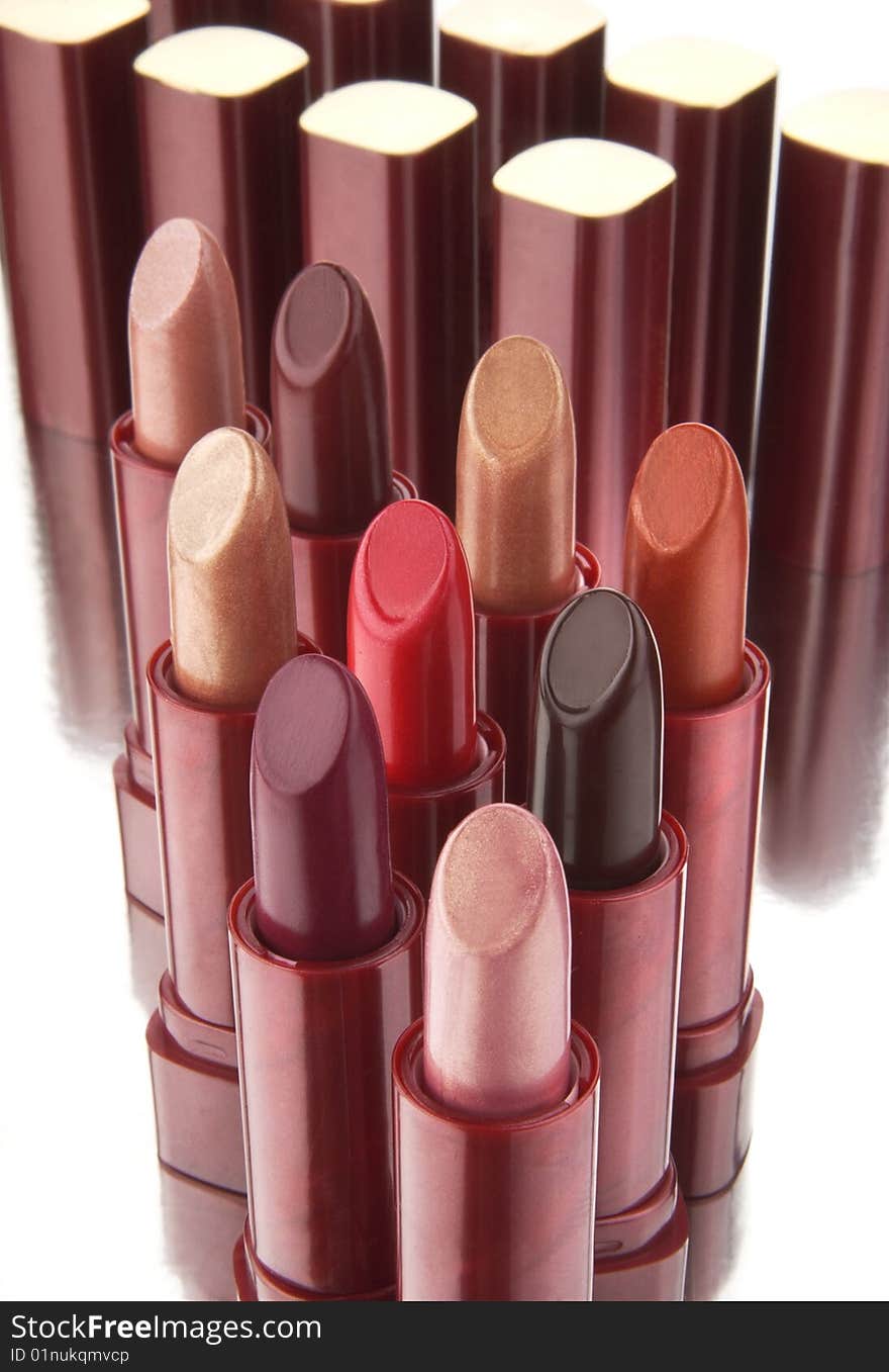 Group of multi-coloured lipsticks on a white background