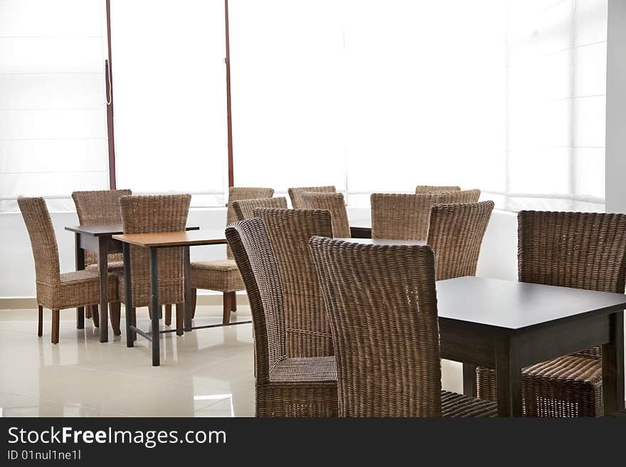 Room with empty wood chairs and tables