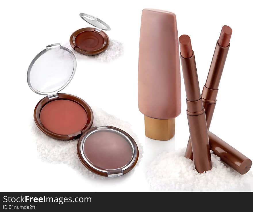 Makeup set: powder, cream, lipstick on a white background