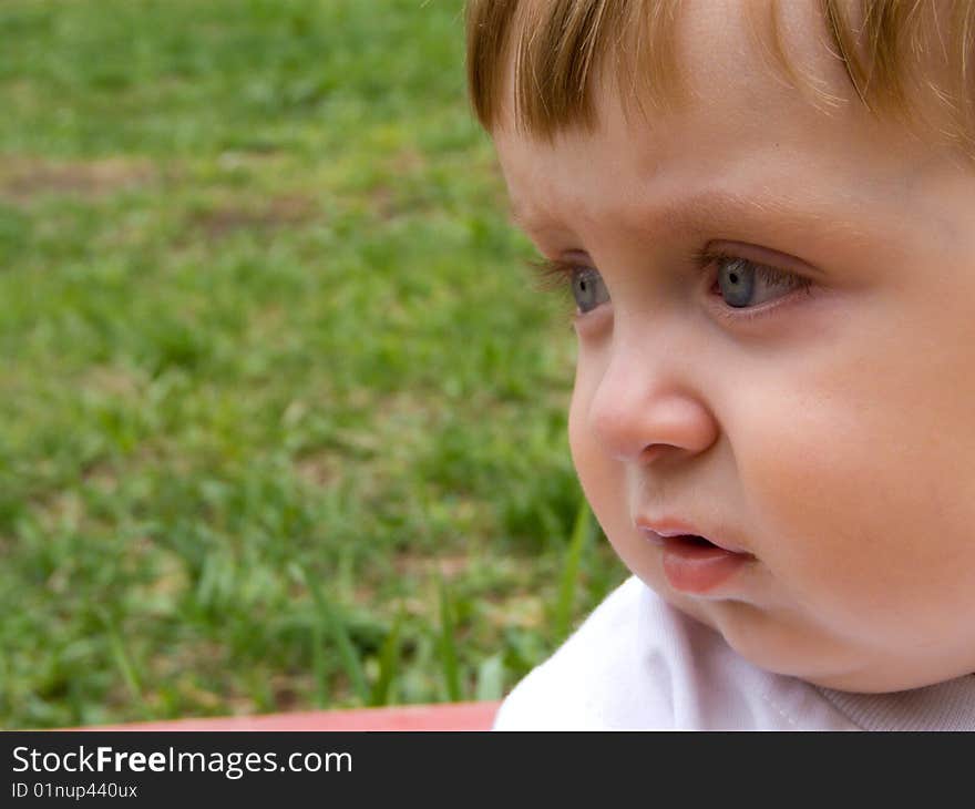 Serious baby-boy in white t-shirt on walk