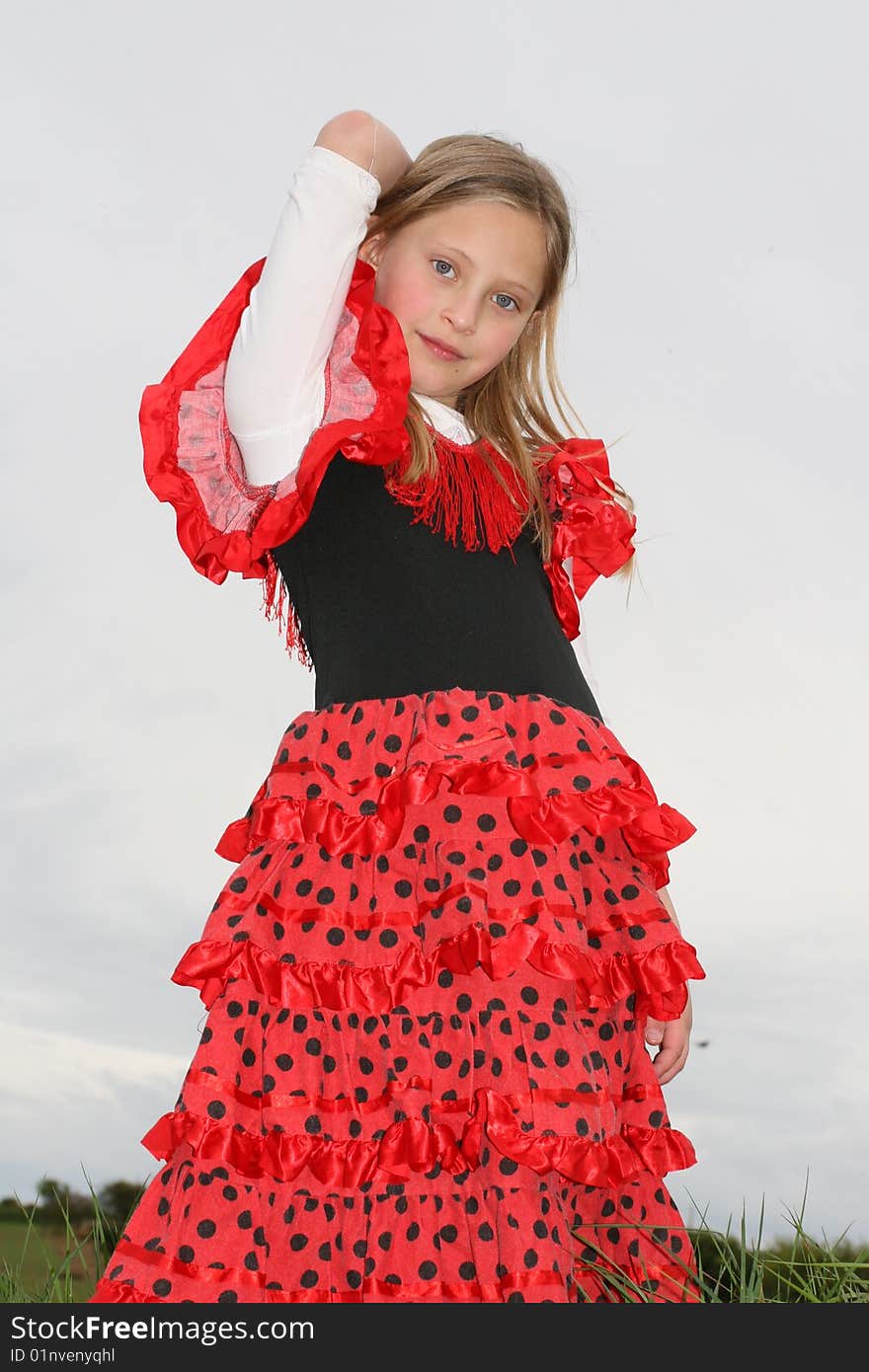 Small girl in red dress posing on the grass. Small girl in red dress posing on the grass