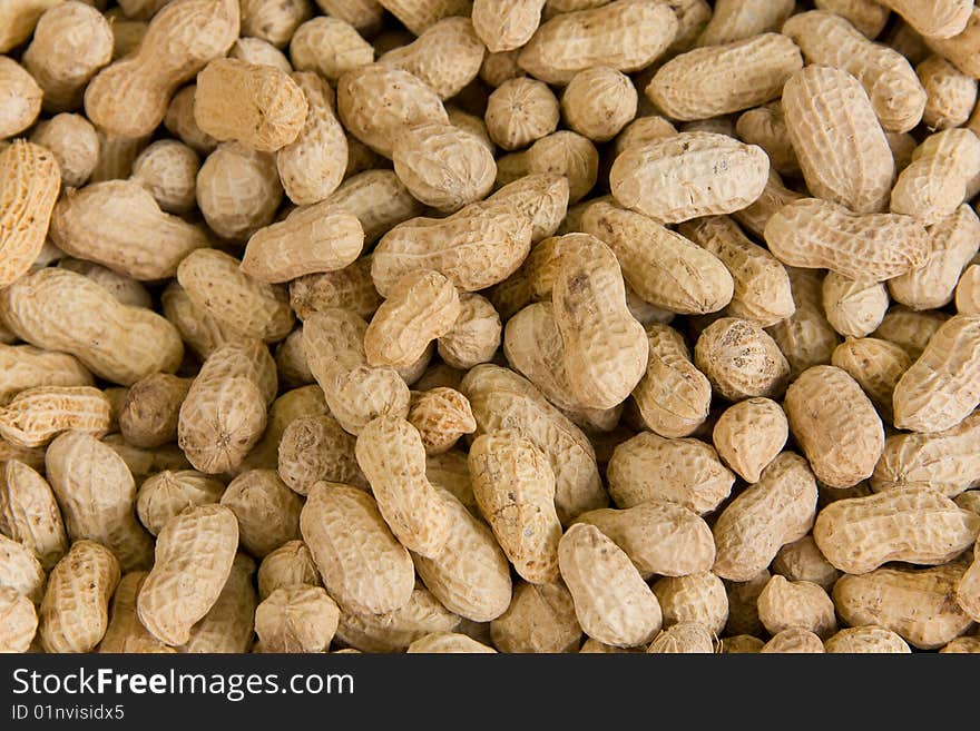 Close up on a huge pile of peanuts.