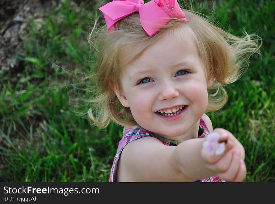 Young Girl Showing Off A Flower