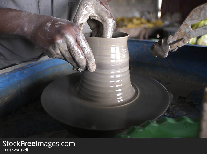 Kenya, hands working a ceramic vase. Kenya, hands working a ceramic vase