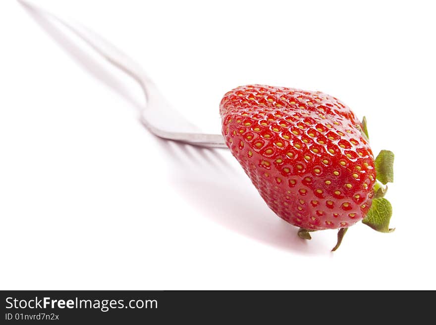 Fork and fresh strawberry isolated on white background