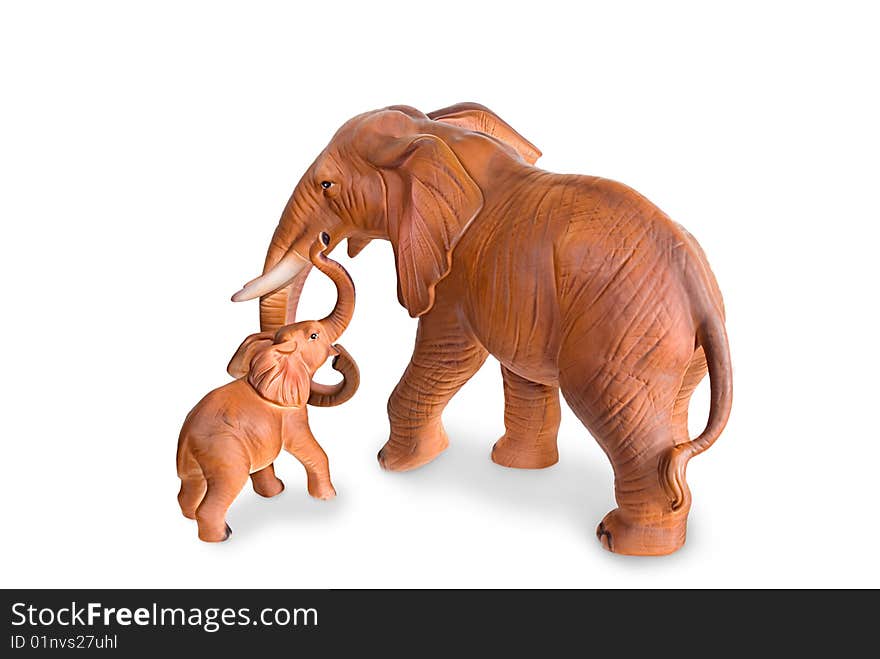 Figurines of an elephant cow and elephant calf are photographed on a white background. Figurines of an elephant cow and elephant calf are photographed on a white background