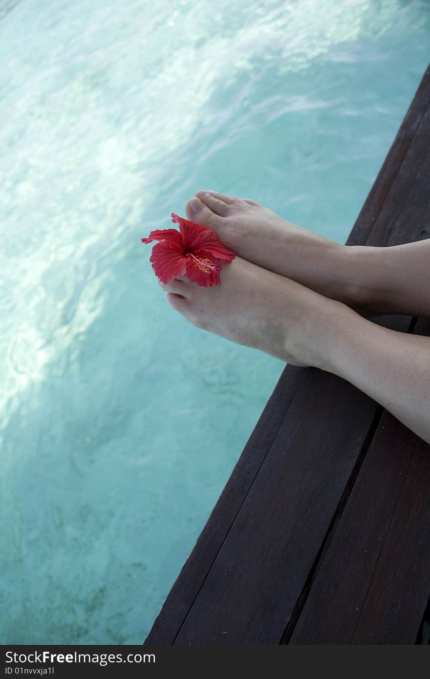 Beautiful legs sitting on water. Beautiful legs sitting on water