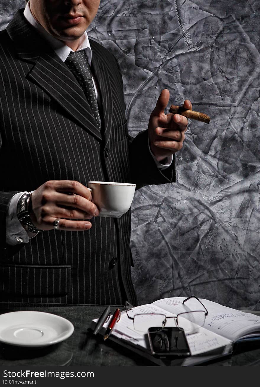 Businessman with a cigar and coffee