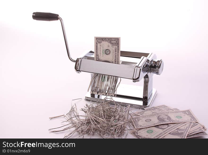 Pasta machine is waisting dollars against a white isolated background with copy-space. Pasta machine is waisting dollars against a white isolated background with copy-space