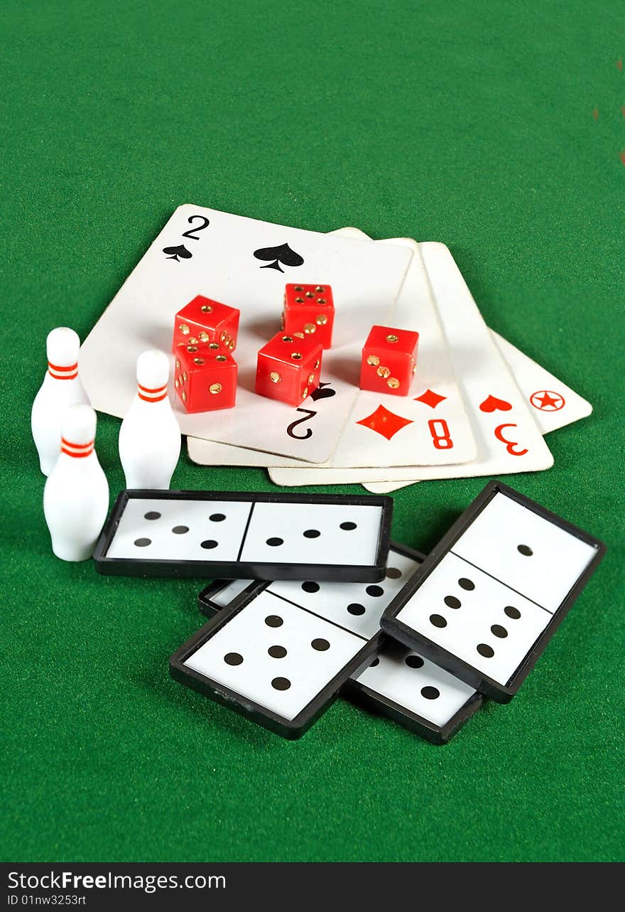 Cards and domino on the green background