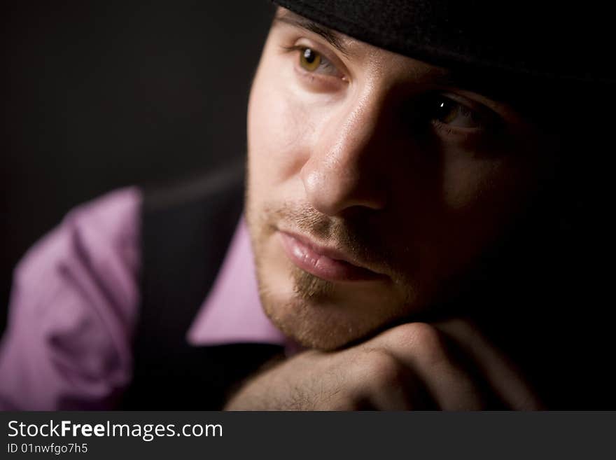 Young man in pink shirt on black floor